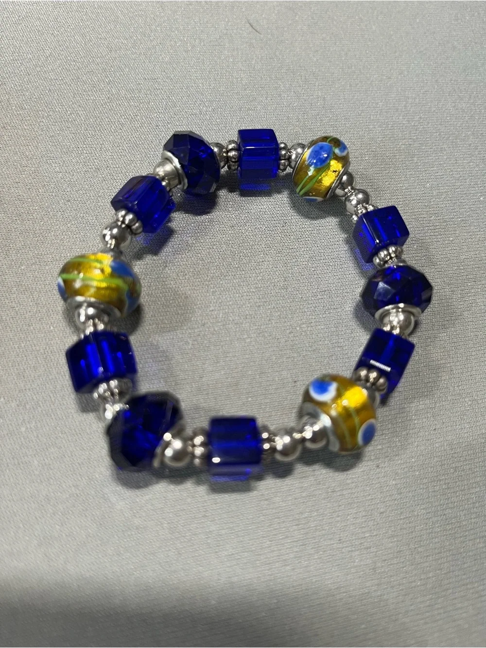 NWOT beautiful blue and yellow plastic beads with silver tone beads in between.